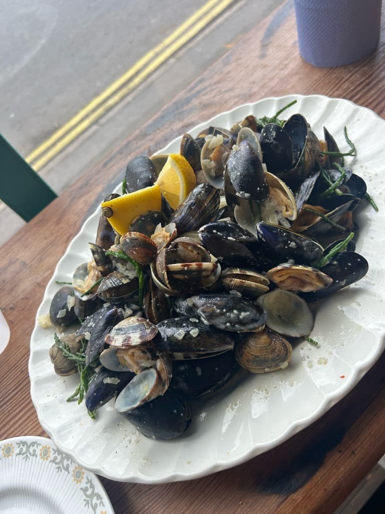 Steaming mussels and clams in white wine sauce